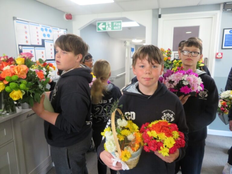 Year 6 pupils from Christ the King Catholic School in Amesbury visited Buckland Court care home, sharing flowers, stories and companionship with residents.
